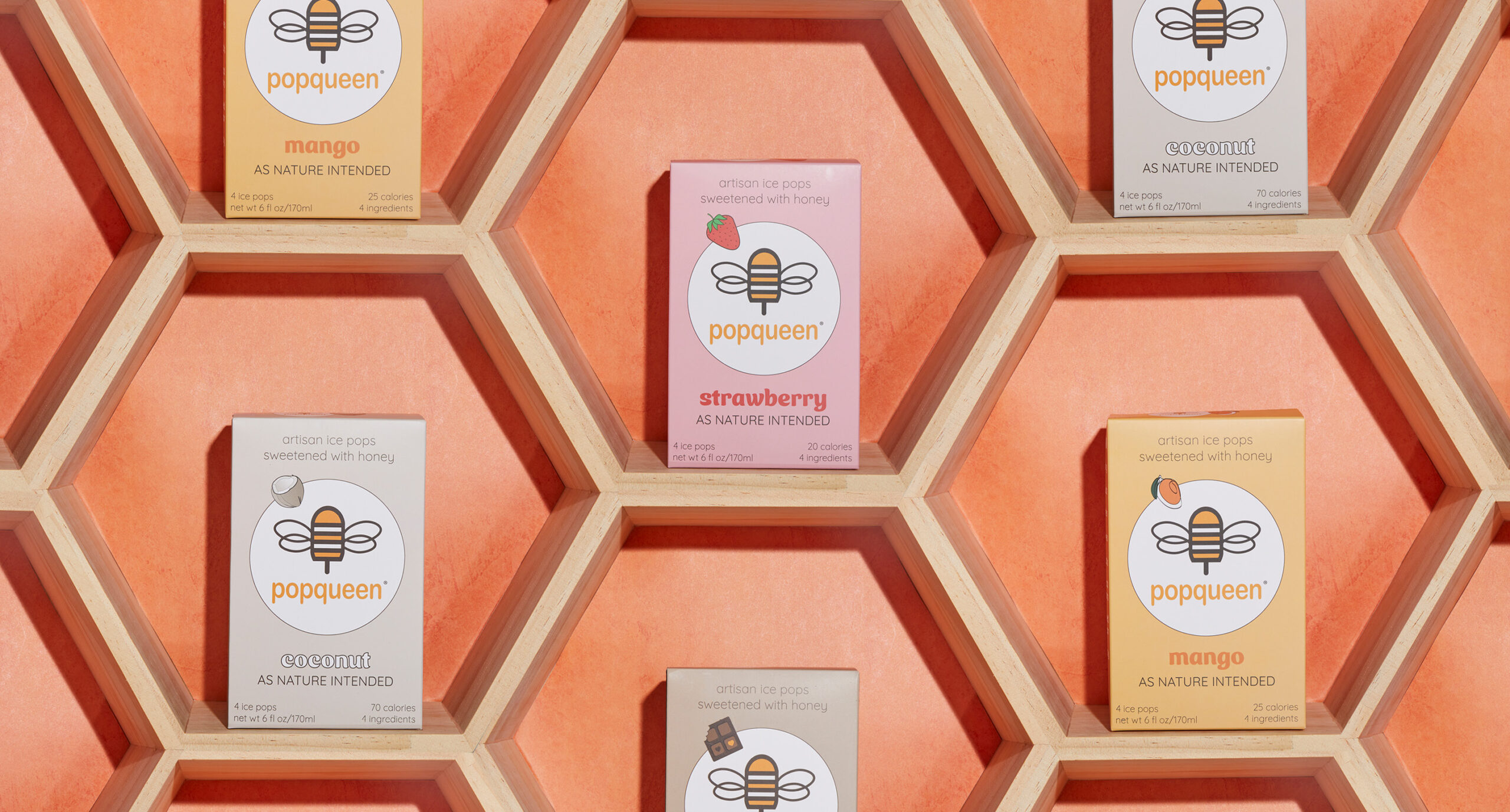 Hexagonal shelves with Popqueen fruit snack boxes—New Arrivals in mango, coconut, and strawberry—are arranged against an orange background resembling a honeycomb pattern.